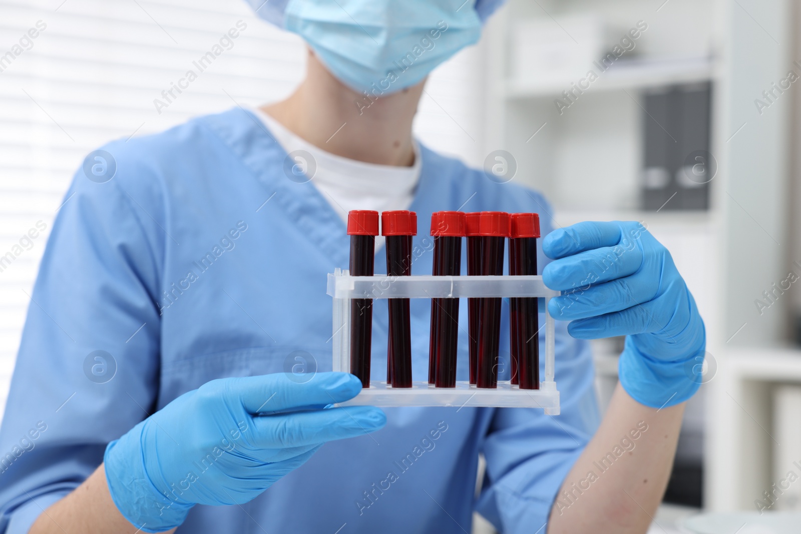 Photo of Laboratory testing. Doctor with blood samples in tubes at hospital, closeup