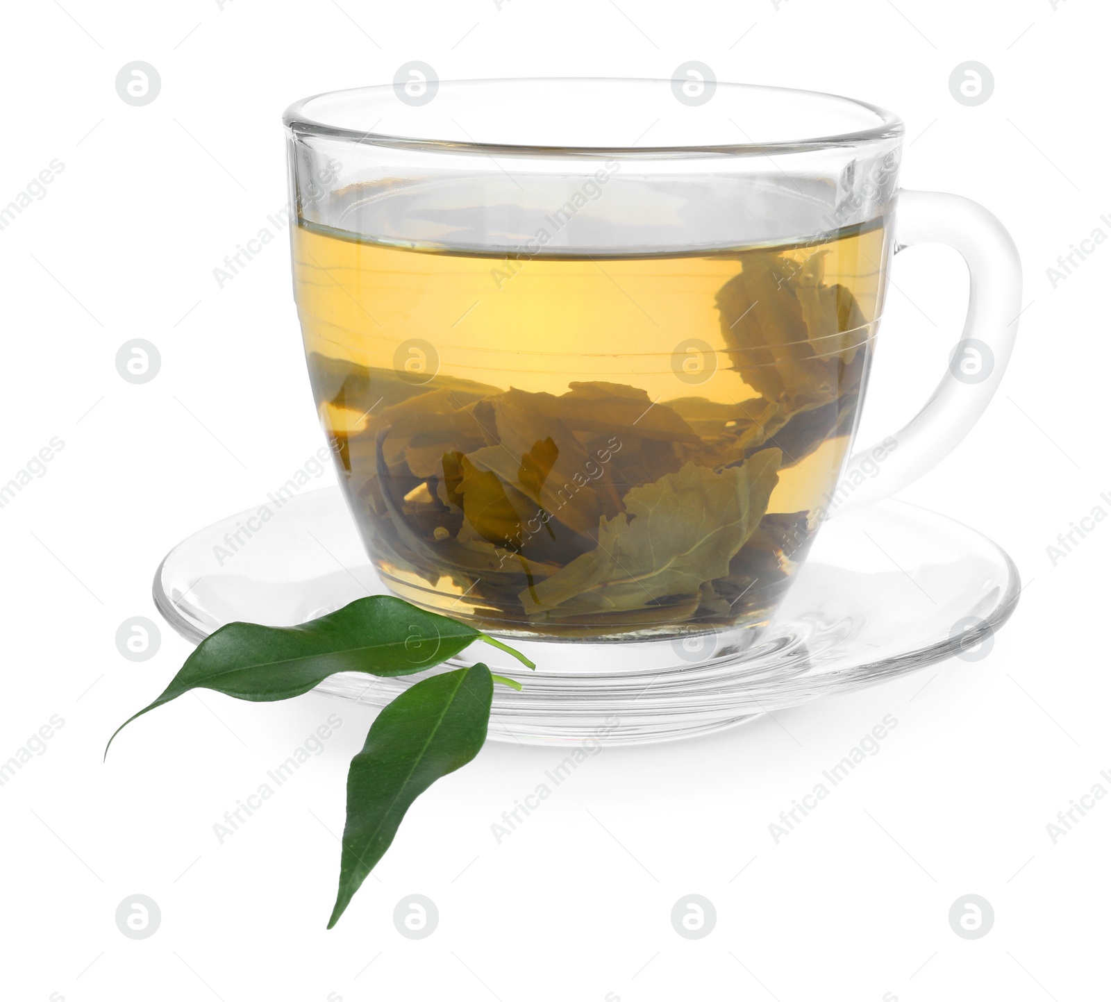 Photo of Fresh green tea in glass cup, leaves and saucer isolated on white