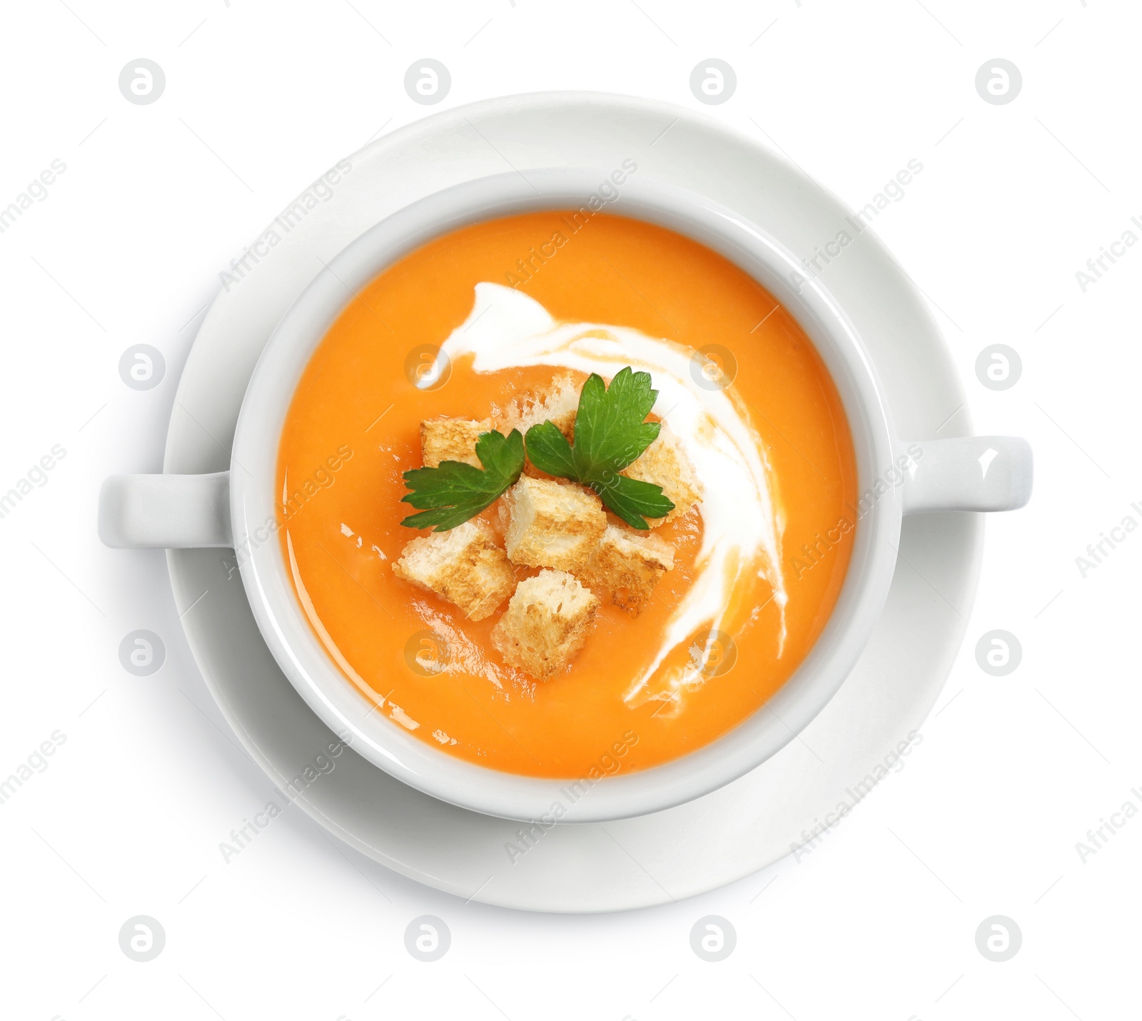 Photo of Delicious pumpkin soup in bowl isolated on white, top view