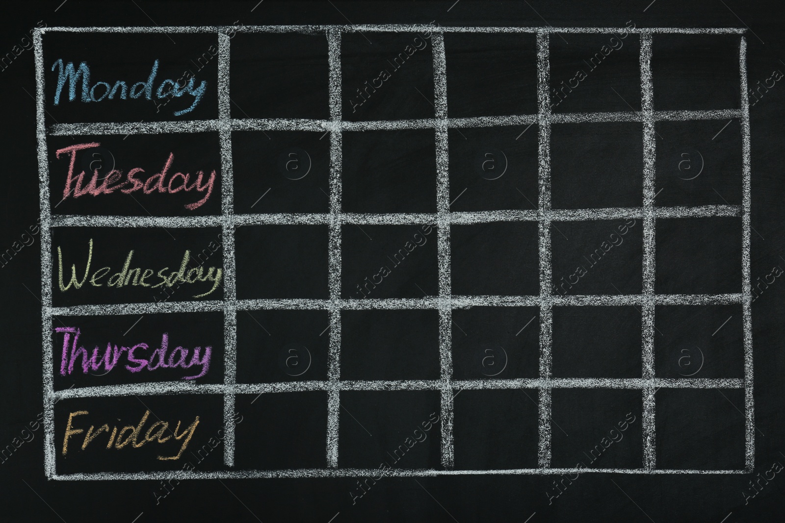 Photo of Weekly school timetable drawn on black chalkboard