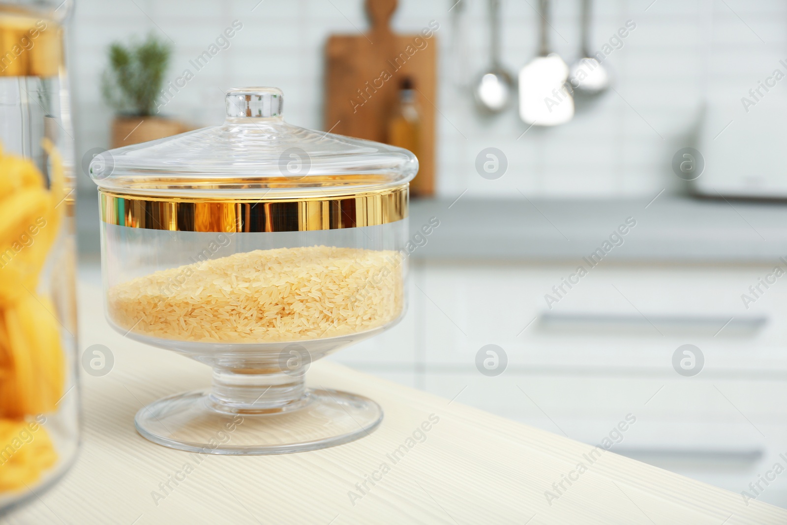 Photo of Products on wooden table in modern kitchen. Space for text