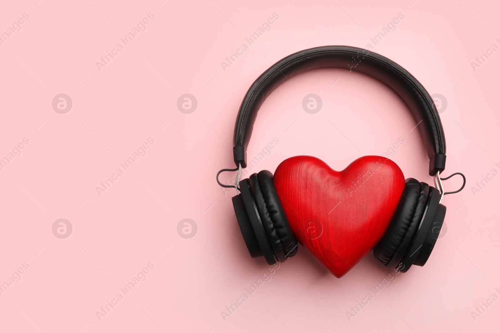 Photo of Decorative heart and modern headphones on color background, flat lay. Space for text