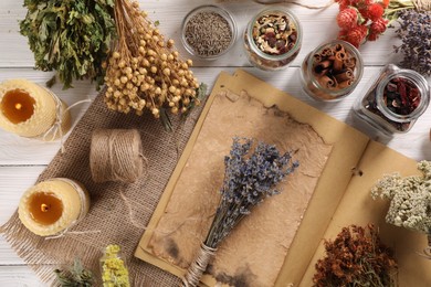Flat lay composition with many different dry herbs and flowers on white wooden table