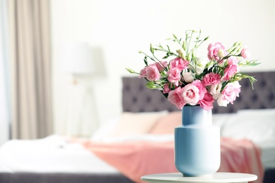 Photo of Vase with beautiful flowers on table in bedroom, space for text