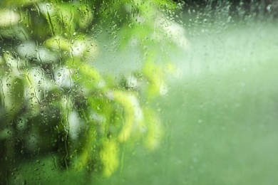 Photo of Window glass with rain drops as background, closeup