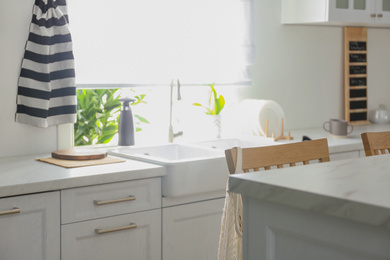 Photo of Modern kitchen interior with stylish white furniture