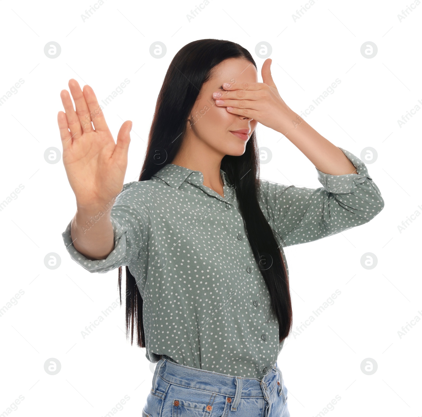 Photo of Embarrassed woman covering face with hand on white background