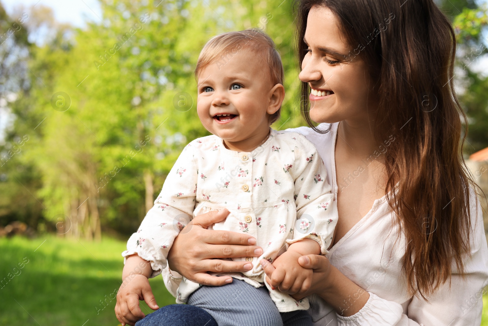 Photo of Happy mother with her cute baby in park on sunny day