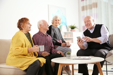 Elderly people spending time together in living room