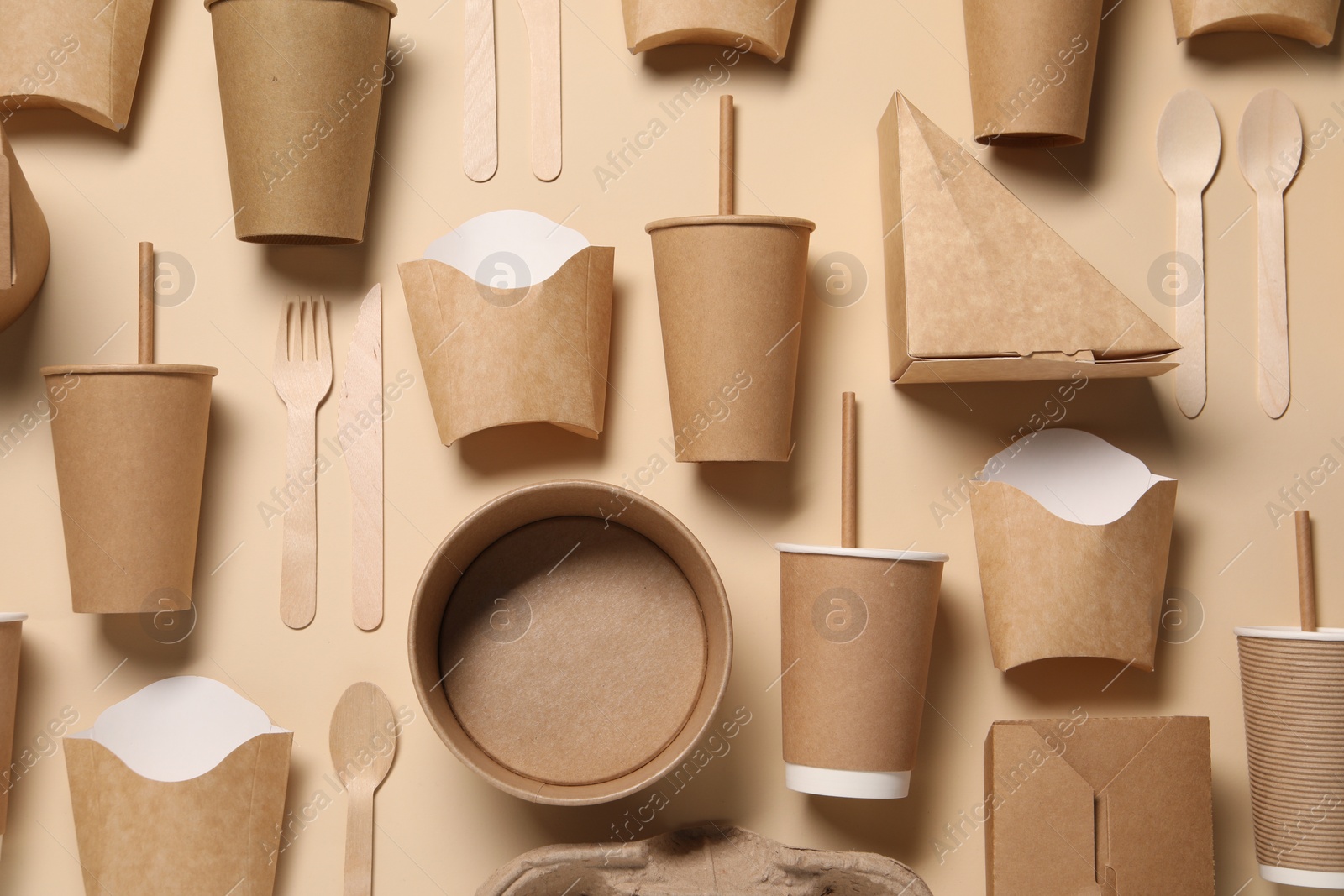 Photo of Flat lay composition with eco friendly food packagings on beige background