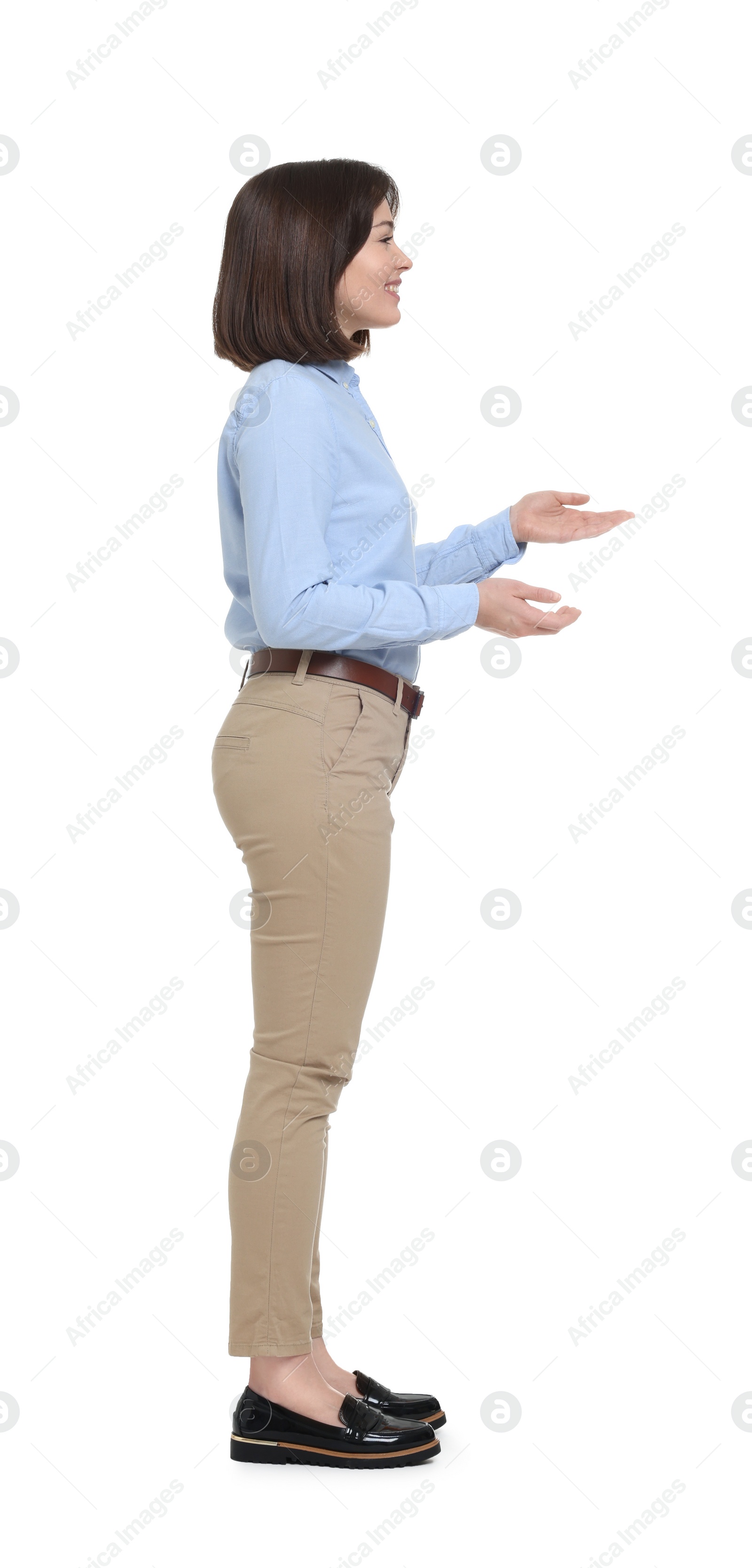 Photo of Happy businesswoman in blue shirt and beige pants on white background