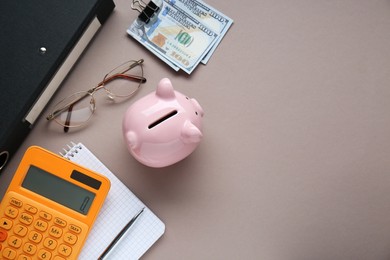 Photo of Flat lay composition with piggy bank, glasses and banknotes on grey background. Space for text