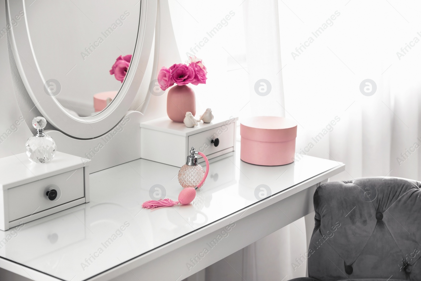 Photo of White dressing table near window in light room