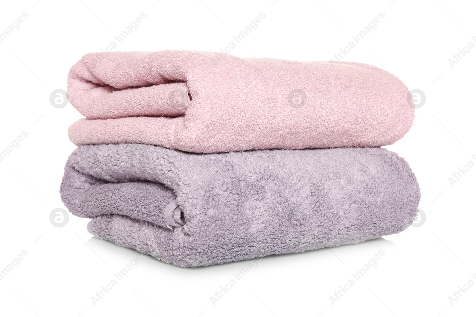 Photo of Folded soft terry towels on white background