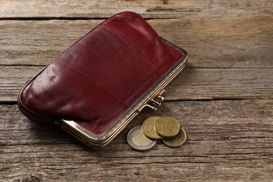 Poverty. Wallet and coins on wooden table