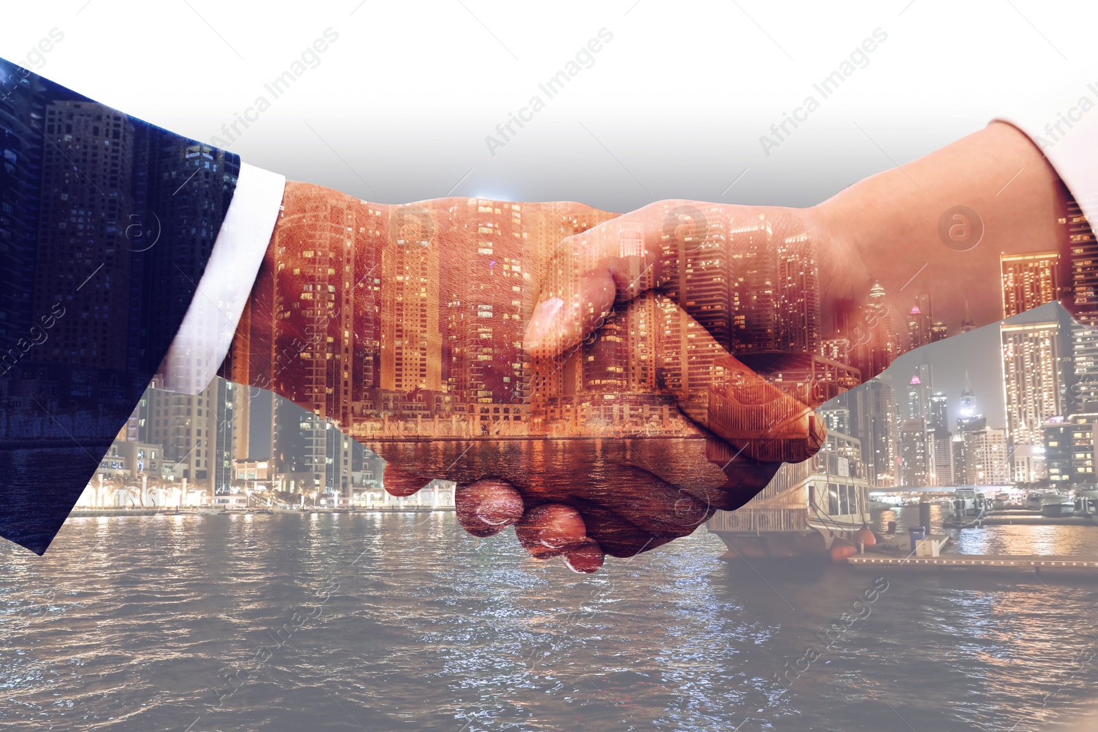 Image of Double exposure of partners shaking hands and cityscape