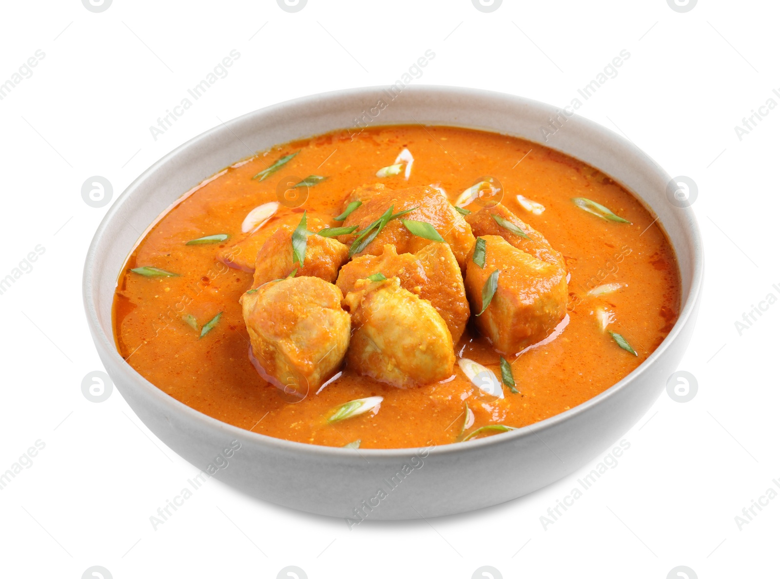 Photo of Bowl of delicious chicken curry on white background