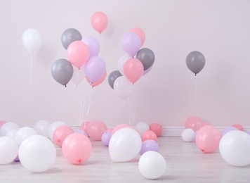 Photo of Room decorated with colorful balloons near wall