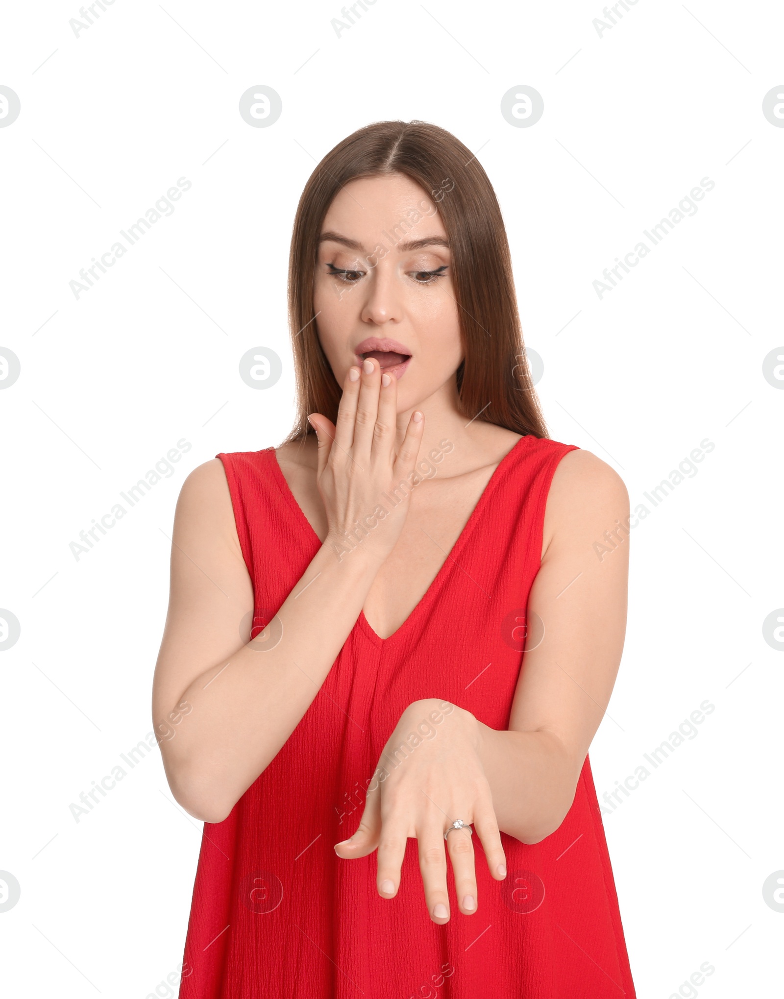 Photo of Emotional young woman wearing beautiful engagement ring on white background