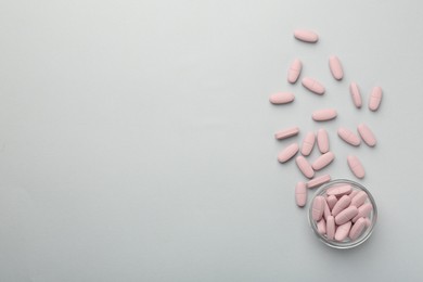 Photo of Vitamin pills on grey background, flat lay. Space for text