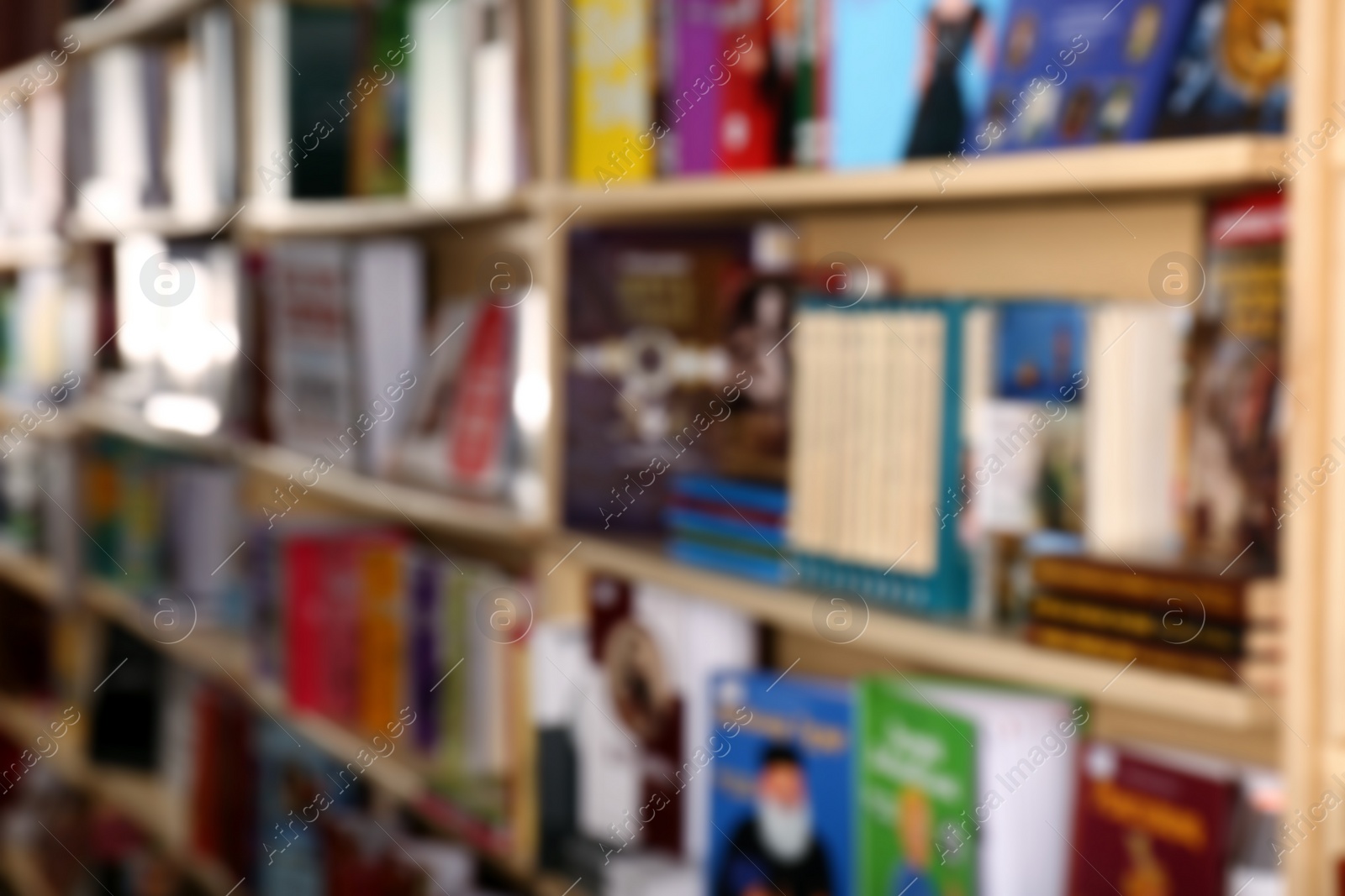 Photo of Blurred view of different books on shelves in library