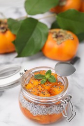 Delicious dessert with persimmon and chia seeds on table