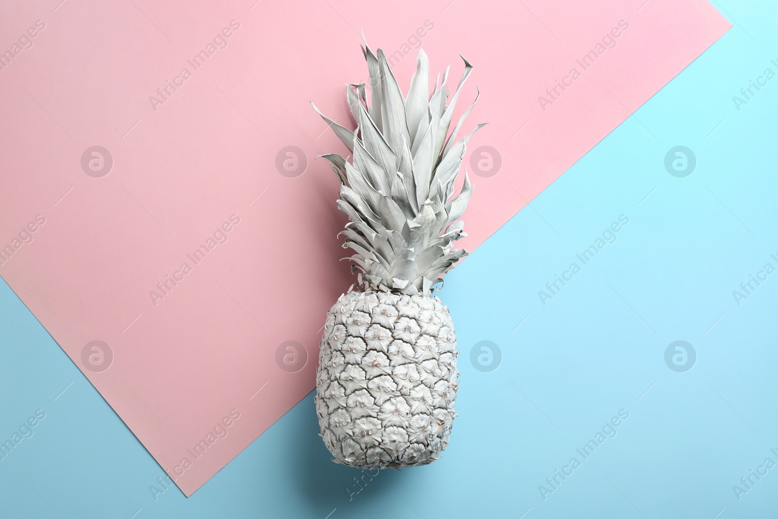 Photo of White pineapple on color background, top view. Creative concept