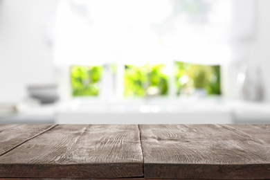 Image of Wooden table in light kitchen. Space for design