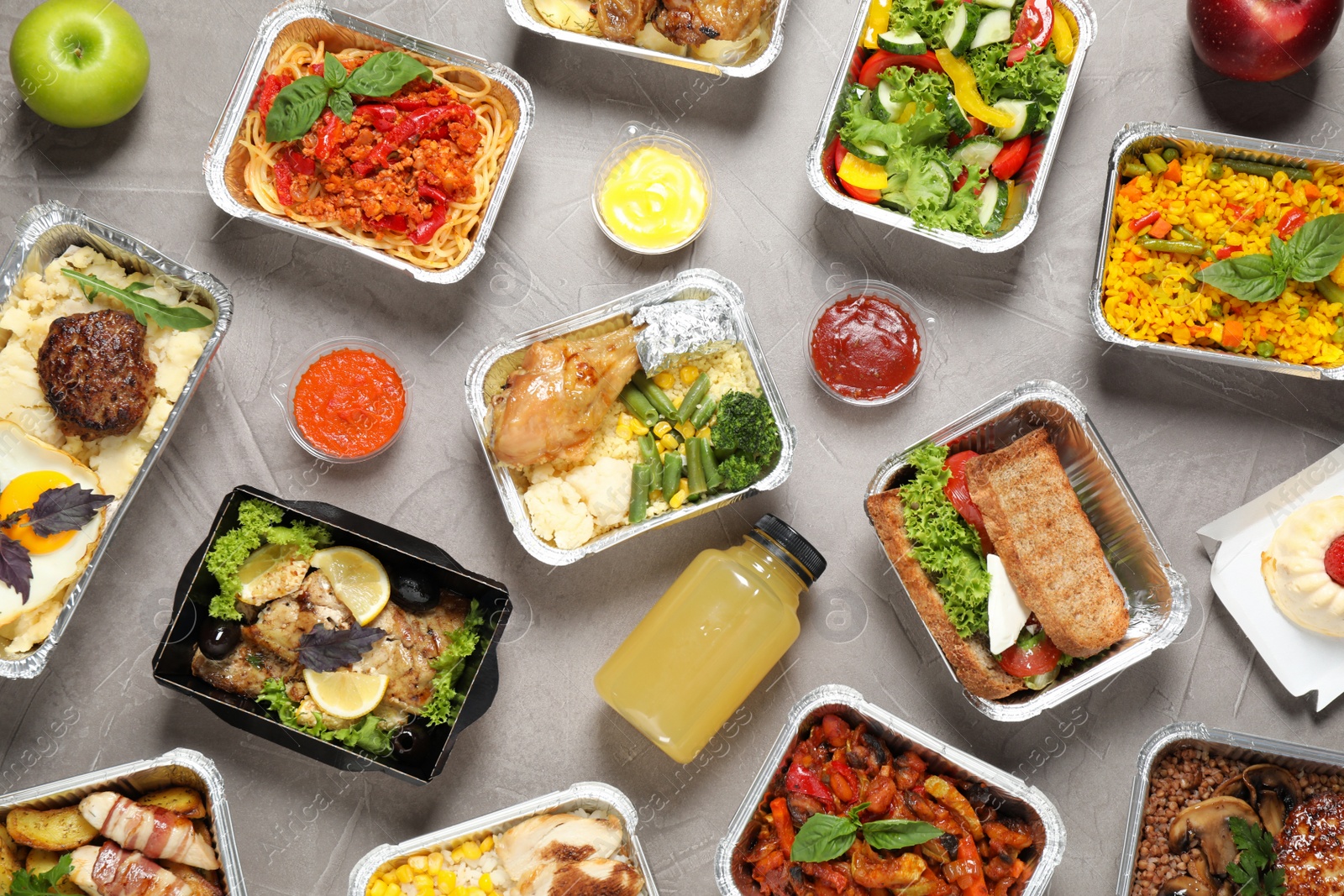 Photo of Lunchboxes on grey table, flat lay. Healthy food delivery