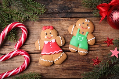 Flat lay composition with gingerbread couple on wooden table