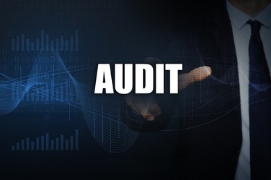 Image of Audit concept. Businessman pointing at word on dark background, closeup. Binary code, graphs and charts