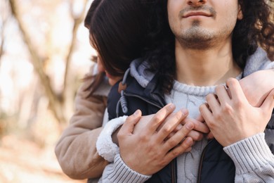 Photo of Young couple hugging outdoors, closeup with space for text. Dating agency
