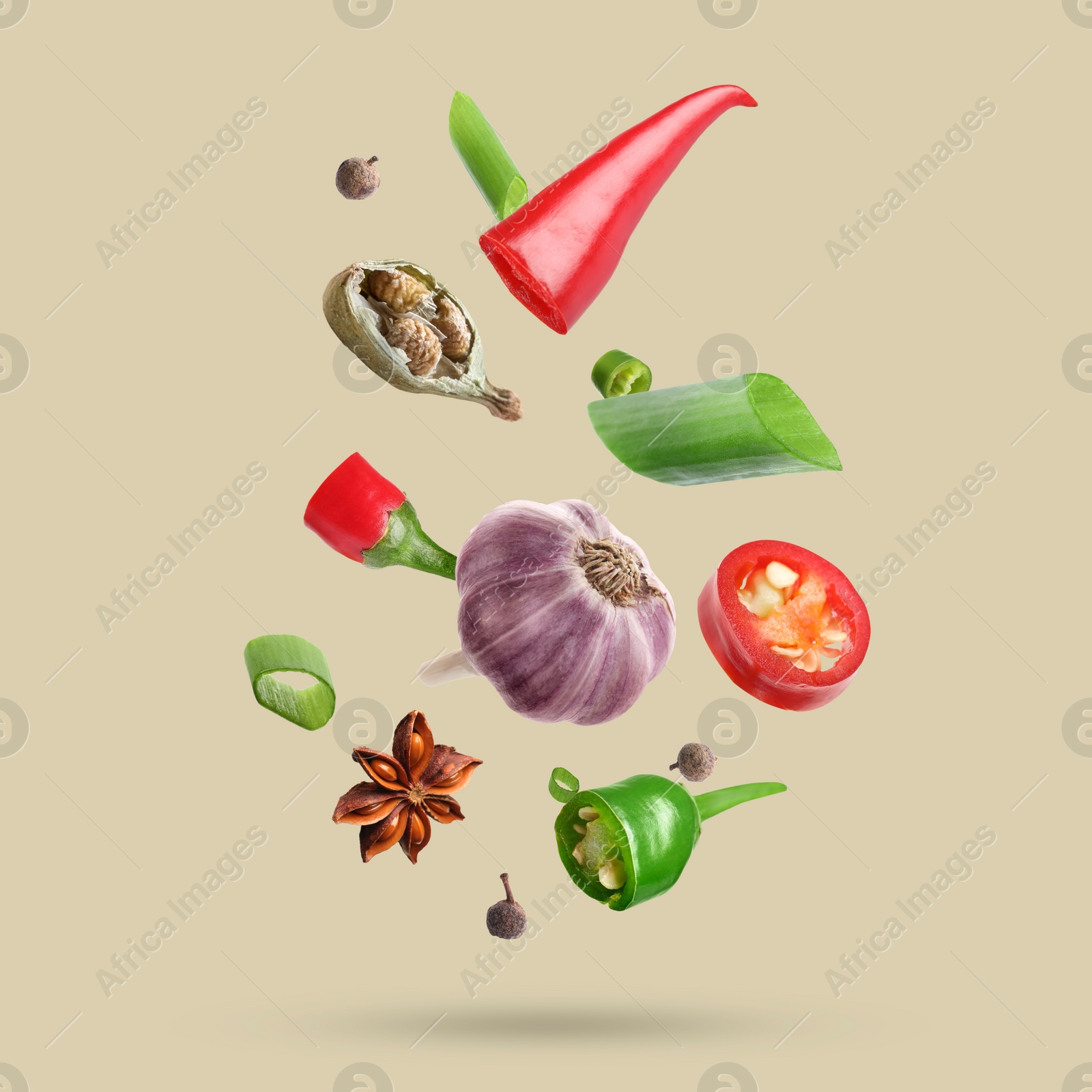 Image of Different spices falling on dark beige background