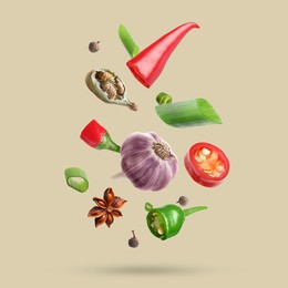 Image of Different spices falling on dark beige background