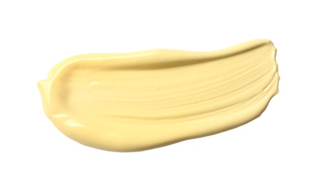 Photo of Stroke of yellow color correcting concealer isolated on white