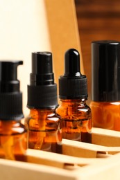 Photo of Bottles with oil in box, closeup. Natural cosmetics