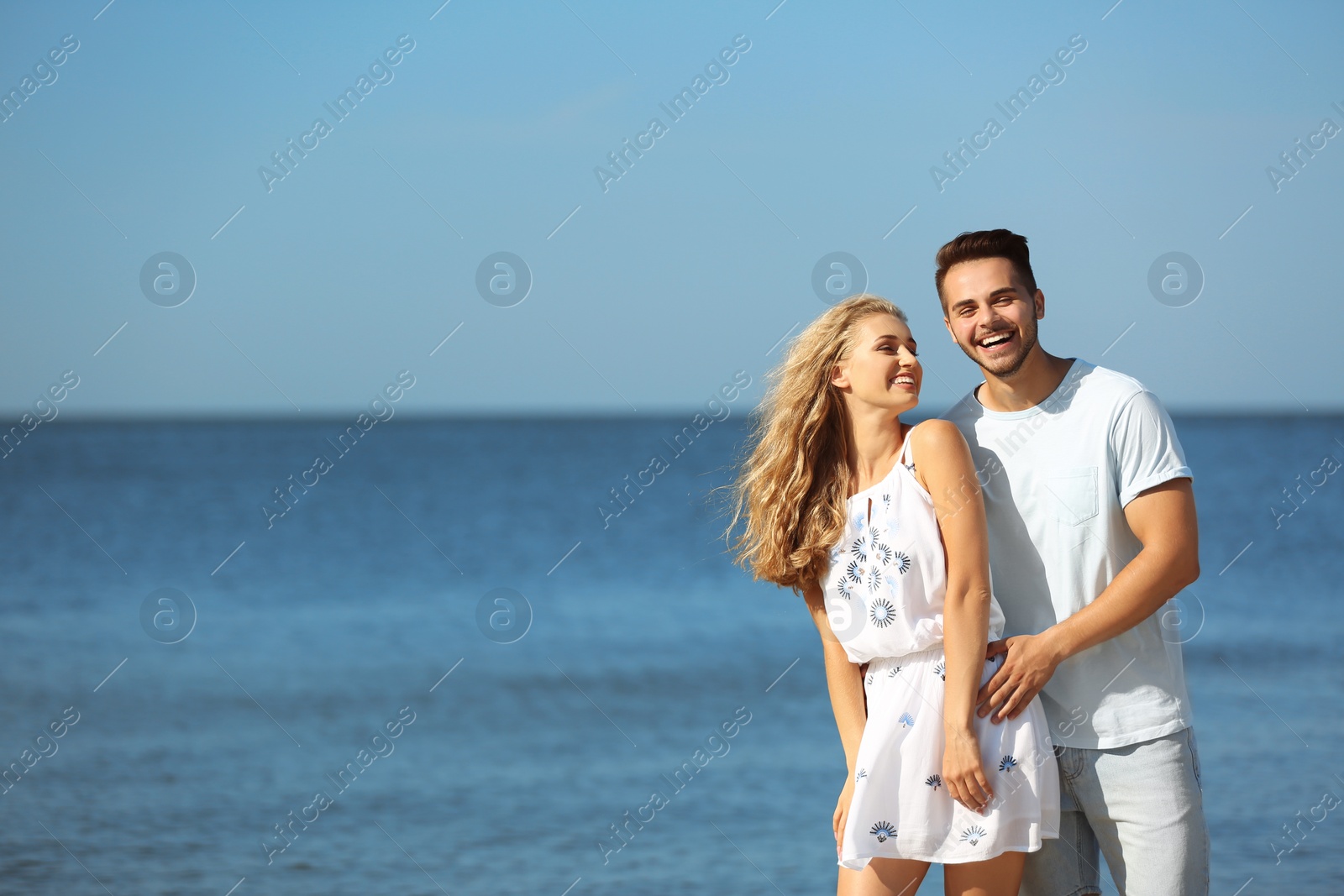 Photo of Happy young couple at beach on sunny day