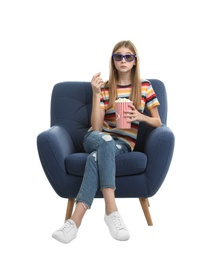 Emotional teenage girl with 3D glasses and popcorn sitting in armchair during cinema show on white background