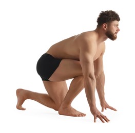 Handsome man in starting position for run on white background