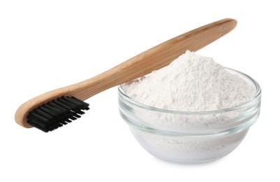 Photo of Glass bowl of tooth powder and brush on white background