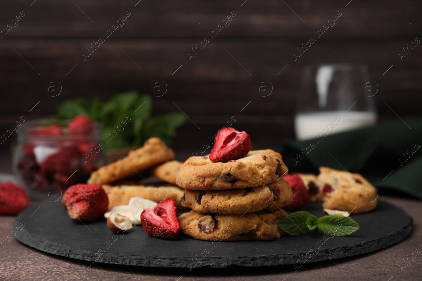 Cookies with freeze dried fruits, mint and nuts on grey table, closeup Photo of Cookies with freeze dried fruits, mint and nuts on grey table, closeup