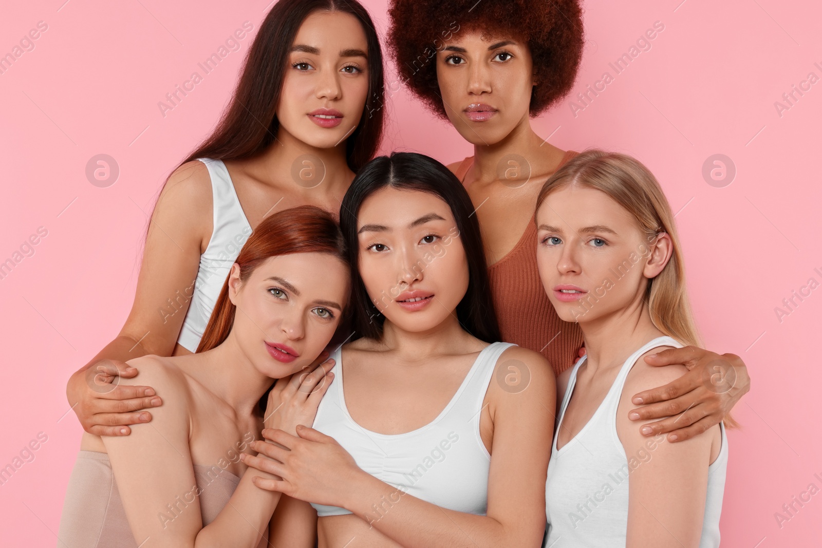 Photo of Portrait of beautiful young women on pink background