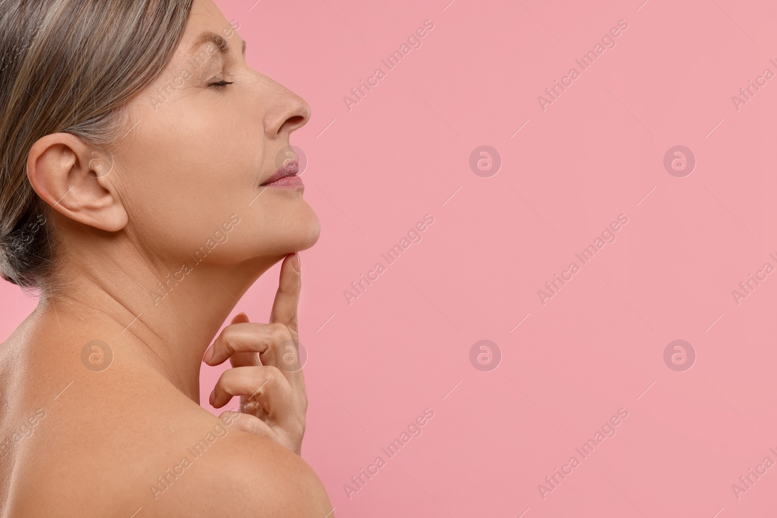 Photo of Beautiful woman with healthy skin on pink background, space for text