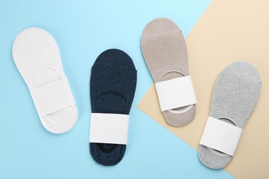 Photo of Soft cotton socks on color background, flat lay