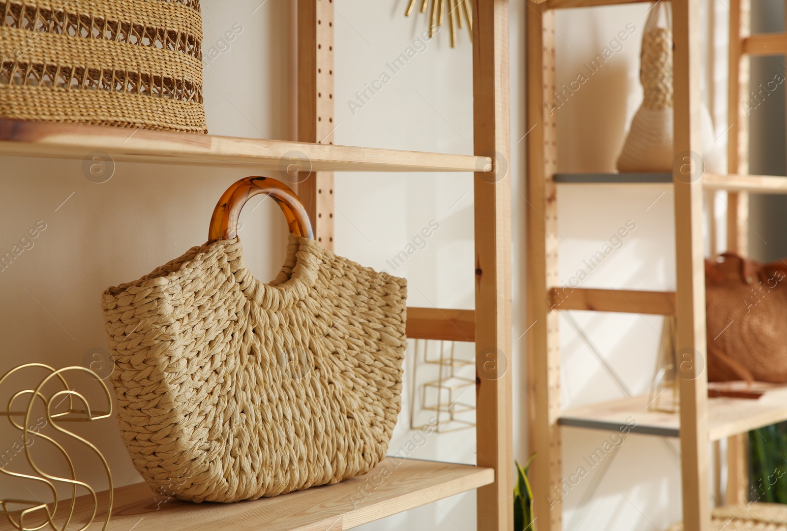 Photo of Stylish woman's bag on shelf in boutique