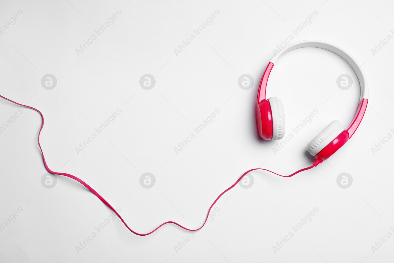 Photo of Stylish modern headphones on white background, top view