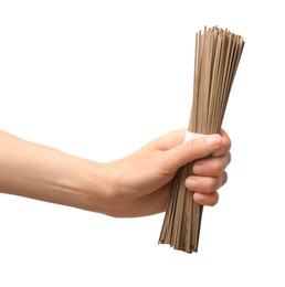 Woman holding uncooked buckwheat noodles (soba) on white background, closeup. Space for text