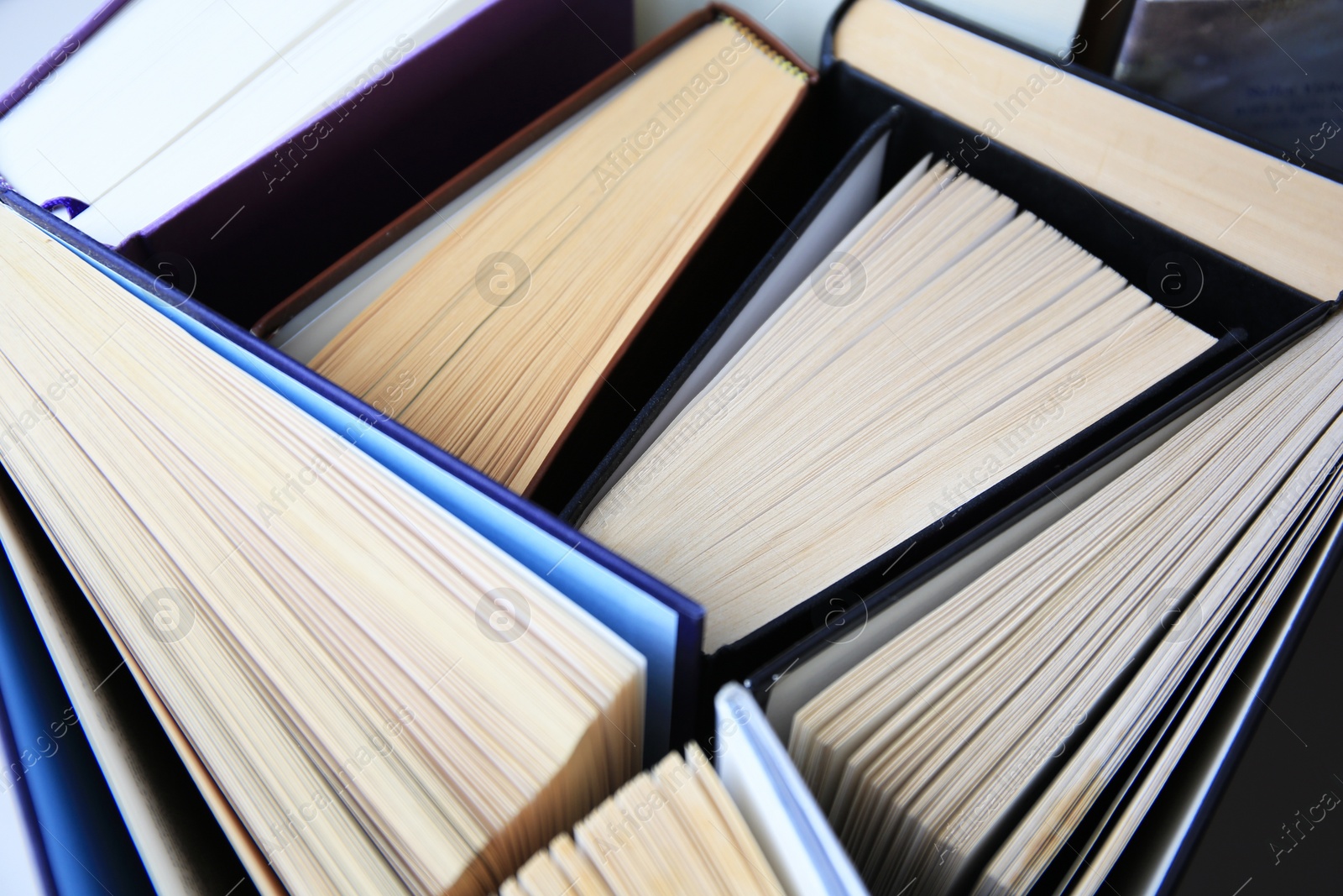 Photo of Collection of different hardcover books, closeup view