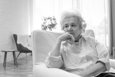 Image of Portrait of mature woman in living room. Black and white photography