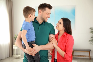 Happy parents and their son at home. Family weekend